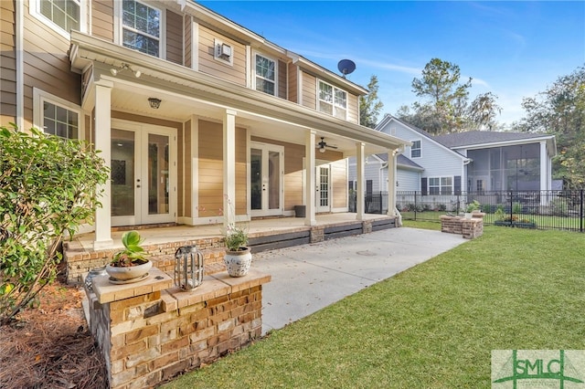 back of property featuring ceiling fan, a yard, a patio, and french doors