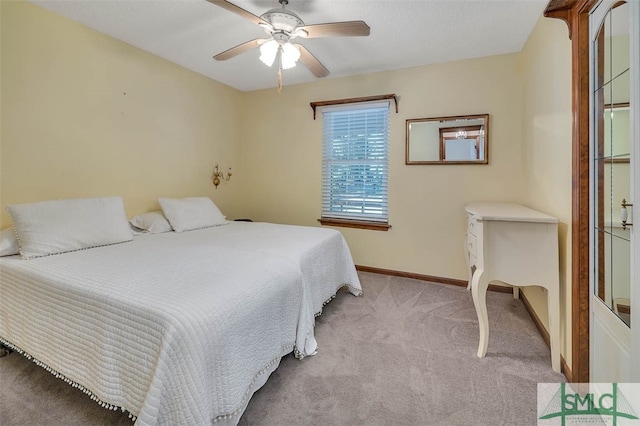 bedroom featuring ceiling fan and light carpet