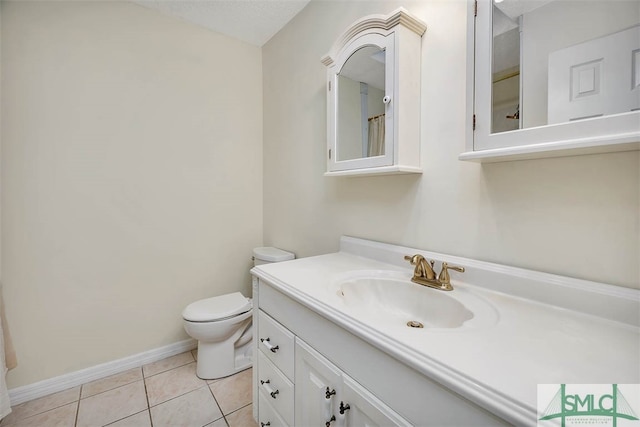 bathroom featuring tile patterned flooring, vanity, and toilet