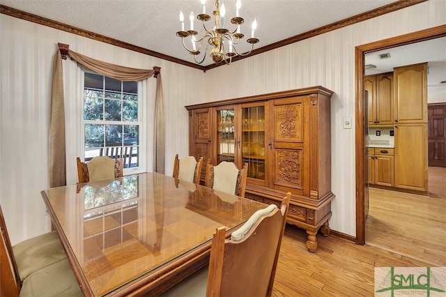 dining room featuring crown molding, light wood-type flooring, a textured ceiling, and an inviting chandelier