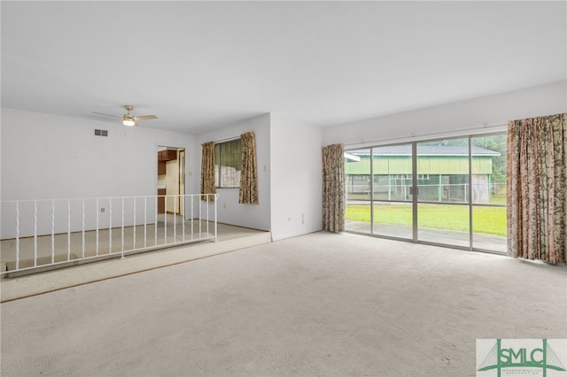 carpeted empty room with ceiling fan