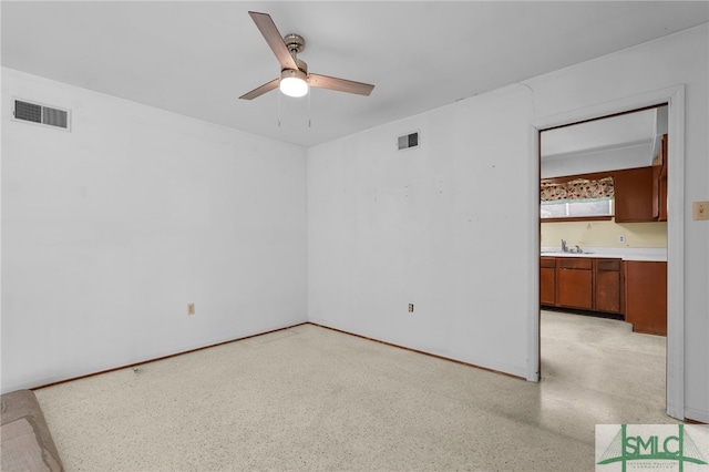 spare room featuring ceiling fan and sink