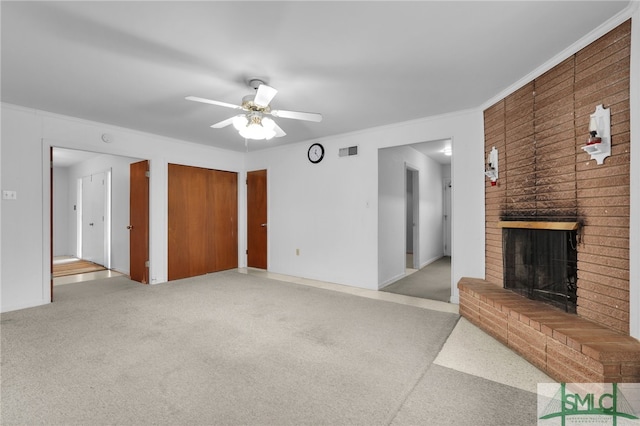 unfurnished living room with a fireplace, ceiling fan, and ornamental molding