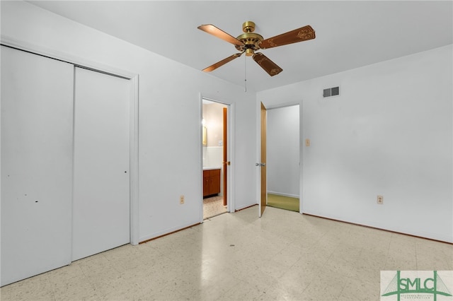 unfurnished bedroom featuring ceiling fan, a closet, and ensuite bathroom