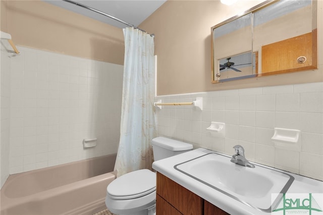 full bathroom with shower / tub combo, vanity, tile walls, and toilet