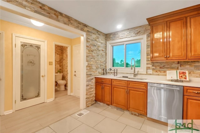 kitchen featuring stainless steel dishwasher, decorative backsplash, light tile patterned flooring, and sink