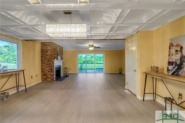 living room with beam ceiling, ceiling fan with notable chandelier, hardwood / wood-style flooring, and coffered ceiling