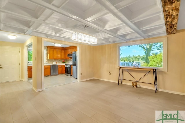 unfurnished living room featuring beamed ceiling, light wood-type flooring, and coffered ceiling