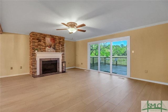 unfurnished living room with ceiling fan, a fireplace, and light hardwood / wood-style floors