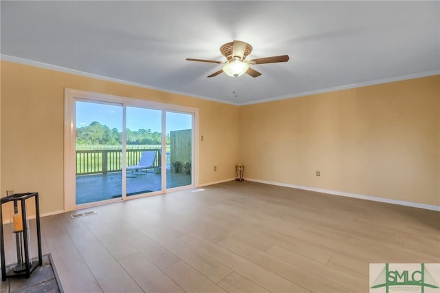 empty room featuring ceiling fan, light hardwood / wood-style floors, and ornamental molding