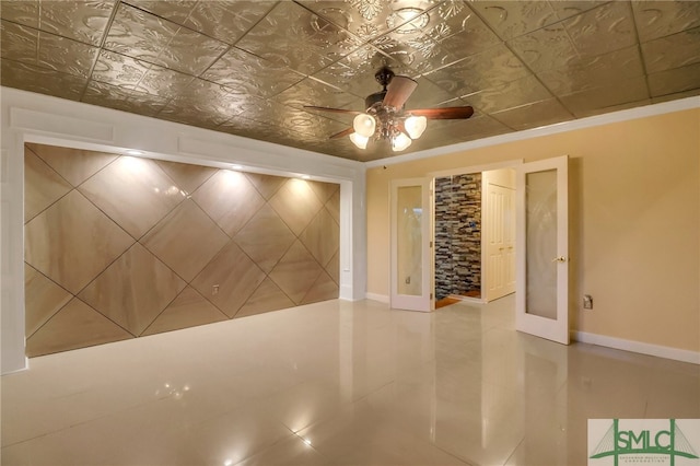 spare room with ceiling fan and french doors