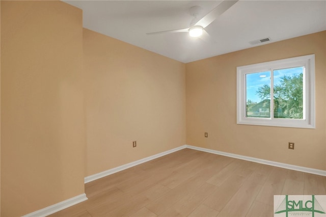 spare room featuring light hardwood / wood-style floors and ceiling fan