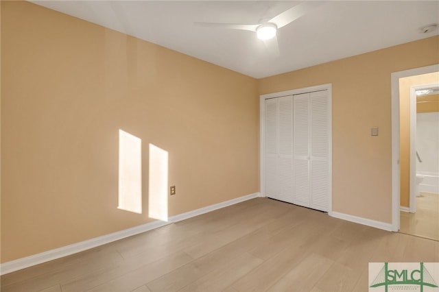 unfurnished bedroom with ceiling fan, light hardwood / wood-style floors, and a closet