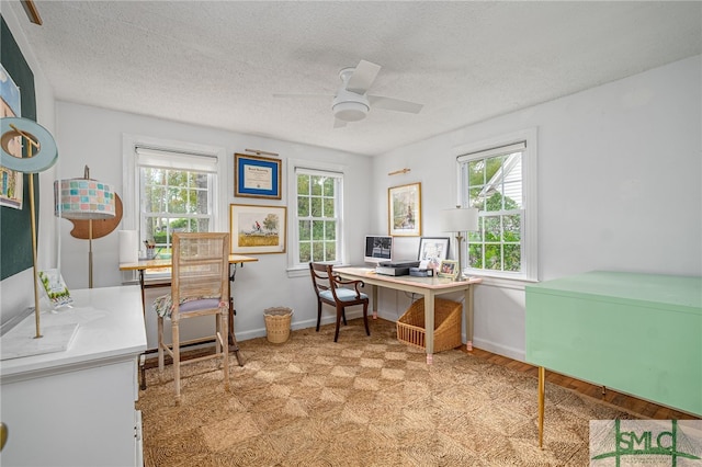 office with ceiling fan, plenty of natural light, and a textured ceiling