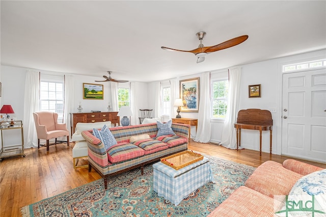 living room with light hardwood / wood-style floors and ceiling fan