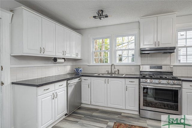 kitchen featuring white cabinetry, sink, and appliances with stainless steel finishes