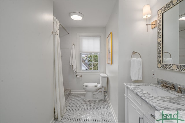 bathroom featuring vanity, a shower with shower curtain, and toilet