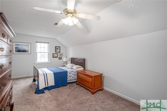 bedroom with ceiling fan, light colored carpet, a textured ceiling, and vaulted ceiling