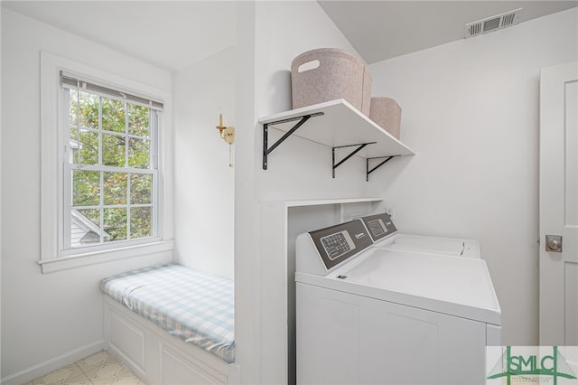 clothes washing area featuring washer and clothes dryer