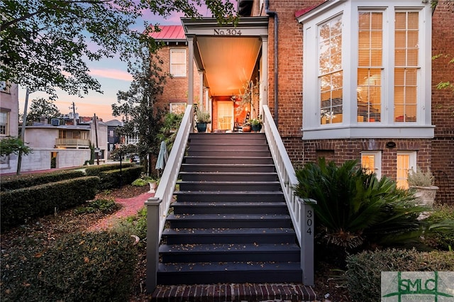 view of exterior entry at dusk