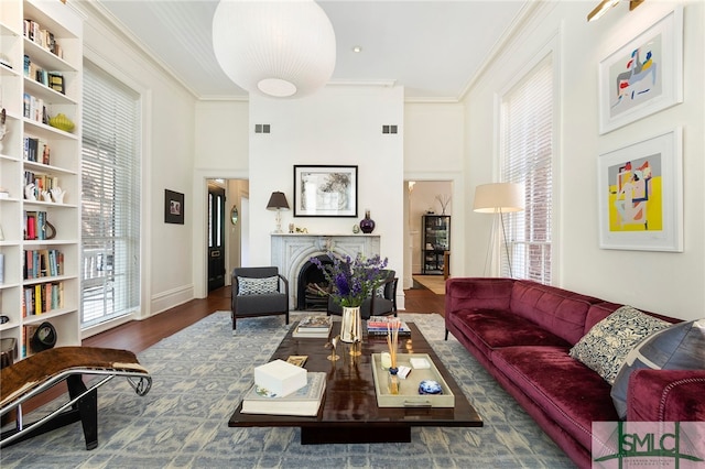 living room featuring crown molding, dark hardwood / wood-style flooring, and a high ceiling