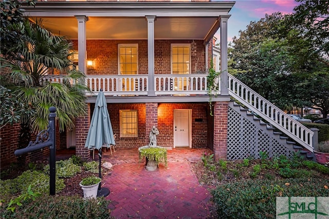 view of back house at dusk