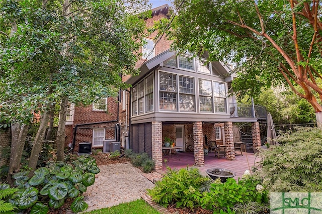 rear view of property with a patio and a sunroom