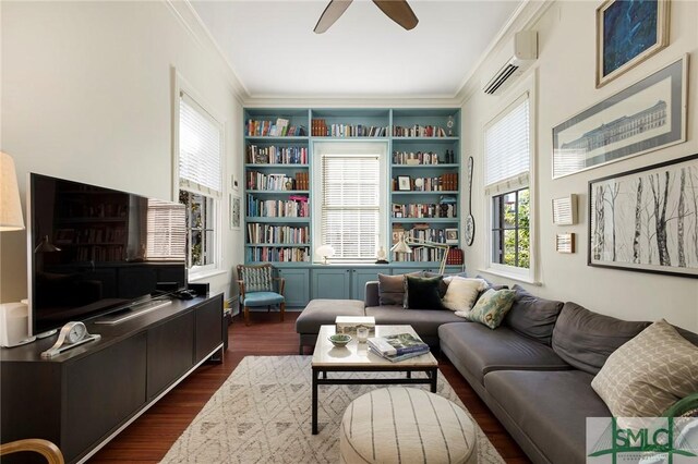 living room with a wall mounted AC, crown molding, built in features, and dark wood-type flooring