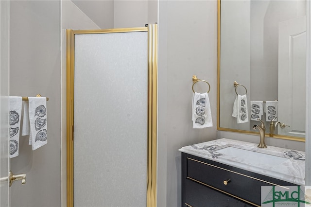 bathroom with vanity and a shower with door