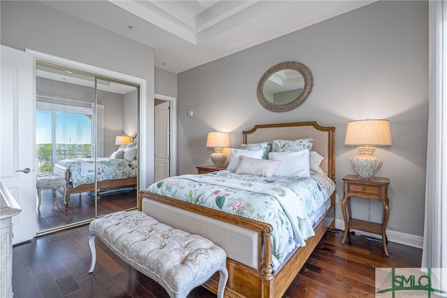 bedroom with a closet and dark wood-type flooring