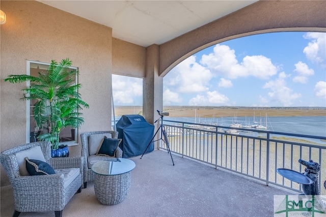 balcony featuring area for grilling and a water view