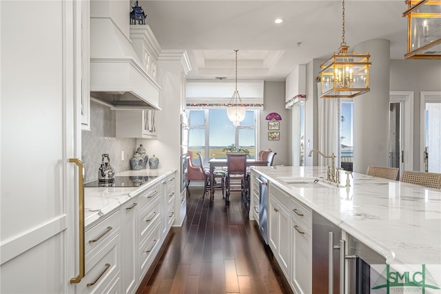 kitchen featuring white cabinets, black electric cooktop, dark hardwood / wood-style floors, and sink