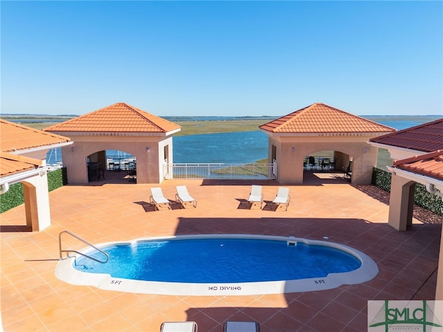 view of swimming pool with a gazebo, a patio area, and a water view