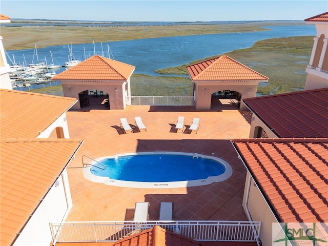 view of swimming pool featuring a gazebo, a water view, and a patio