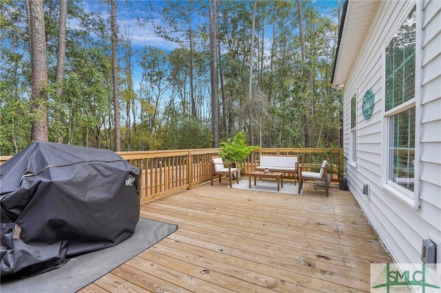 wooden terrace with outdoor lounge area and a grill