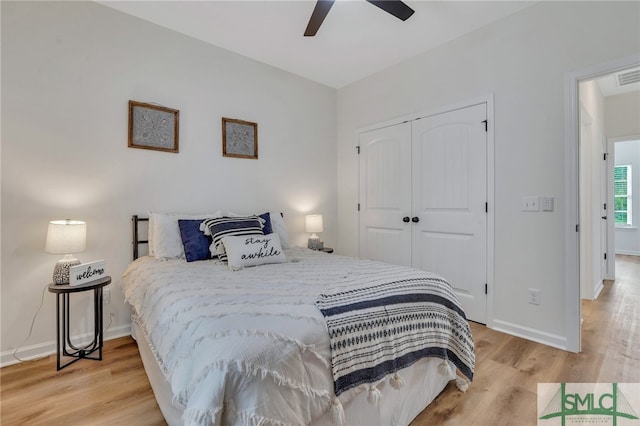 bedroom featuring ceiling fan, a closet, and light hardwood / wood-style floors