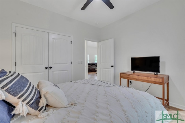 bedroom featuring ceiling fan, light hardwood / wood-style floors, and a closet