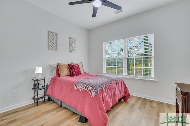 bedroom with ceiling fan and hardwood / wood-style floors