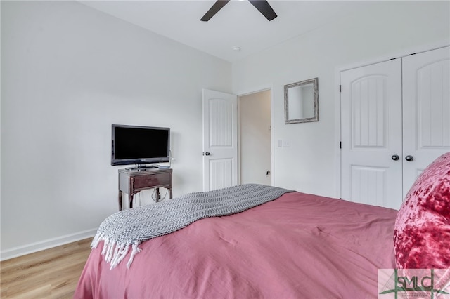 bedroom featuring ceiling fan, a closet, and light wood-type flooring