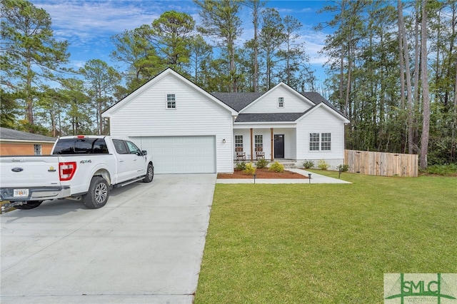 view of front of house featuring covered porch, a garage, and a front lawn