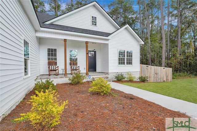 view of front of house with a porch and a front yard