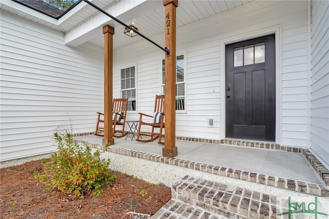 view of exterior entry with covered porch