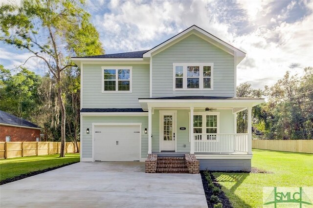 view of front facade with covered porch, a garage, and a front yard