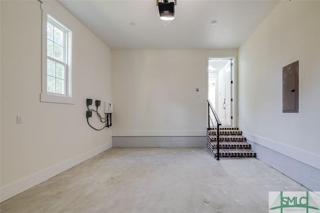 garage with electric panel and a garage door opener