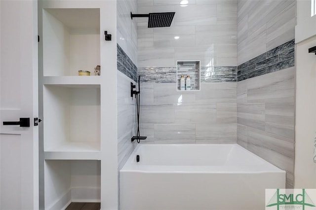 bathroom featuring built in features and tiled shower / bath