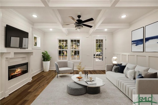 living room with coffered ceiling, plenty of natural light, beamed ceiling, and dark hardwood / wood-style flooring