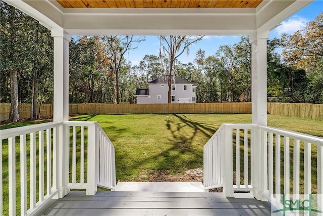 wooden terrace with a yard