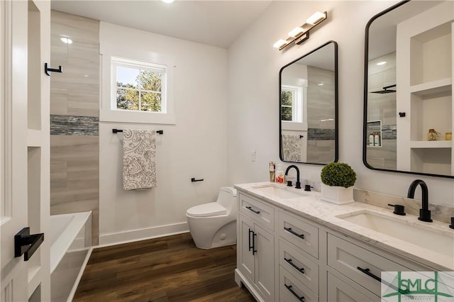 full bathroom with hardwood / wood-style flooring, vanity, independent shower and bath, and toilet