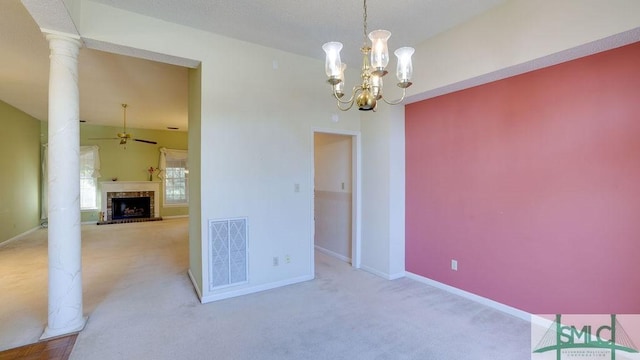 unfurnished room with ornate columns, light carpet, and ceiling fan with notable chandelier