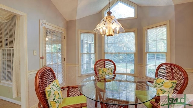 dining area featuring an inviting chandelier and vaulted ceiling